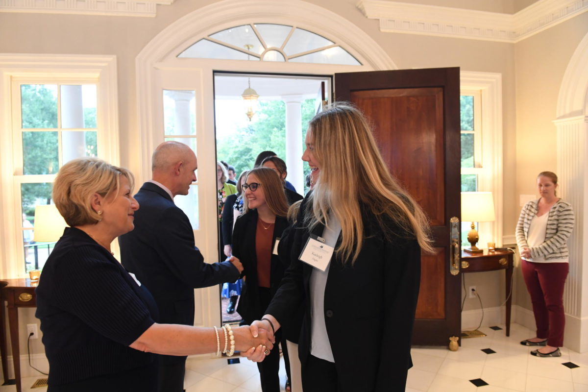 President Kelly and Mrs. Kelly greet students in their home, photo by Savannah Dunn/ The Captains Log