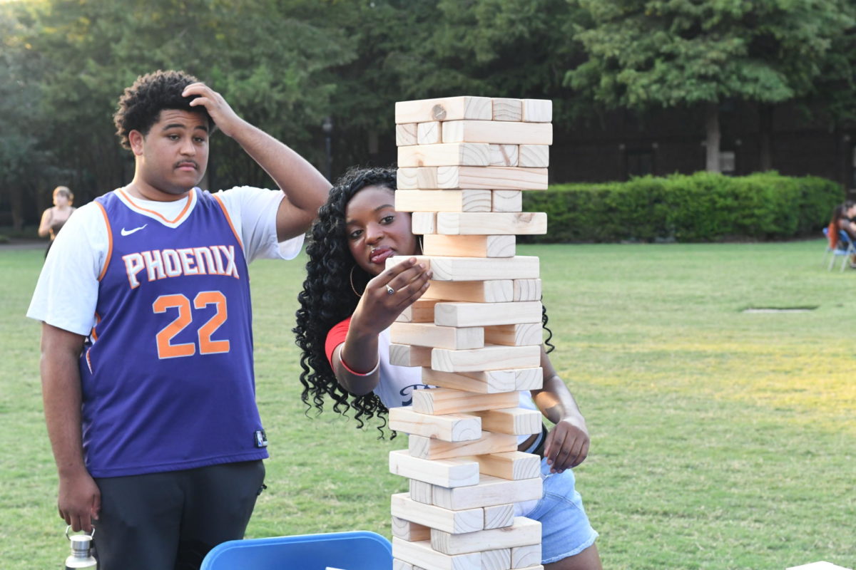 Attendees of the cookout playing Jenga