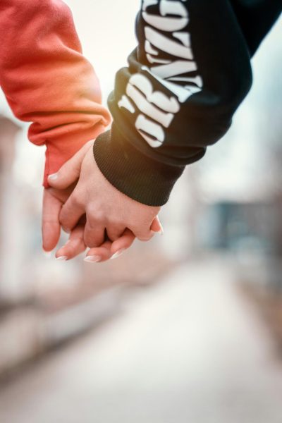 A couple holding hands, photo from Unsplash