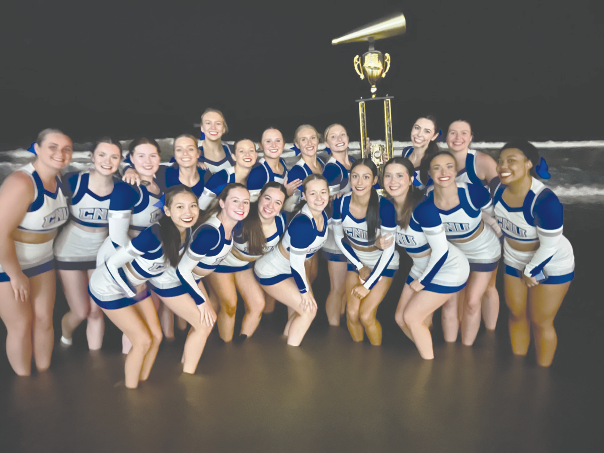 The+cheer+team+posing+with+their+first+place+trophy%2Cphoto%0Acourtesy+of+head+coach+Erica+Flannigan