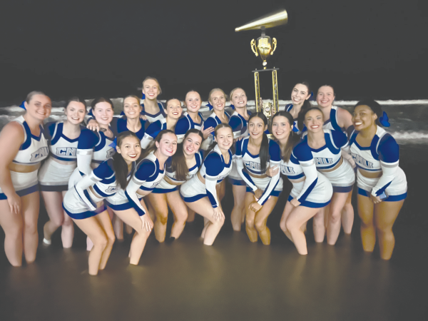The cheer team posing with their first place trophy,photo
courtesy of head coach Erica Flannigan