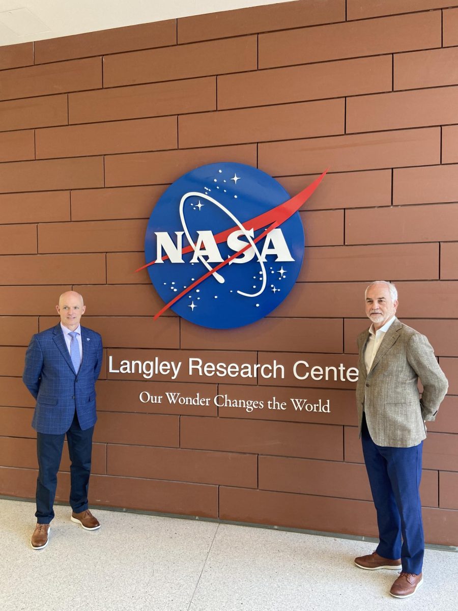 President Kelly and Provost Kidd posing for a picture in front of the NASA building
