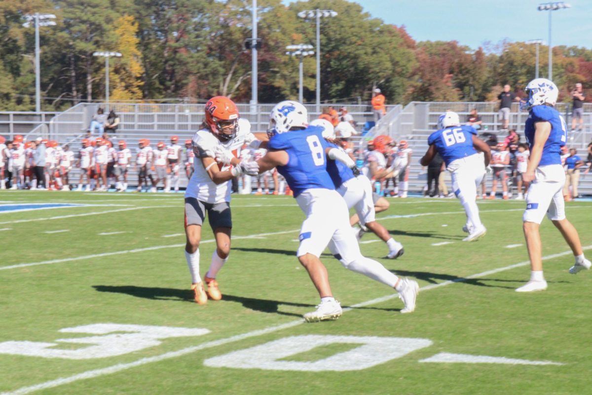 Defensive Back Isaak Mihalap blocking his opponent