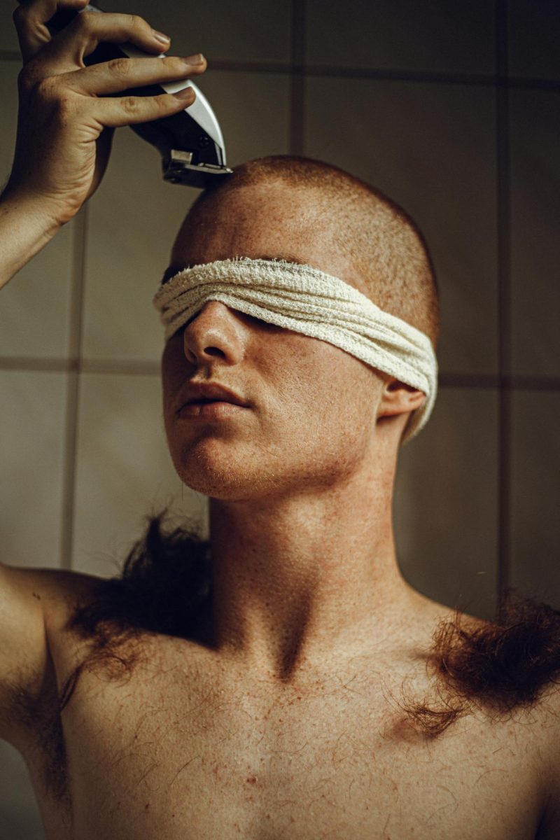 Person shaving their head, from Unsplash