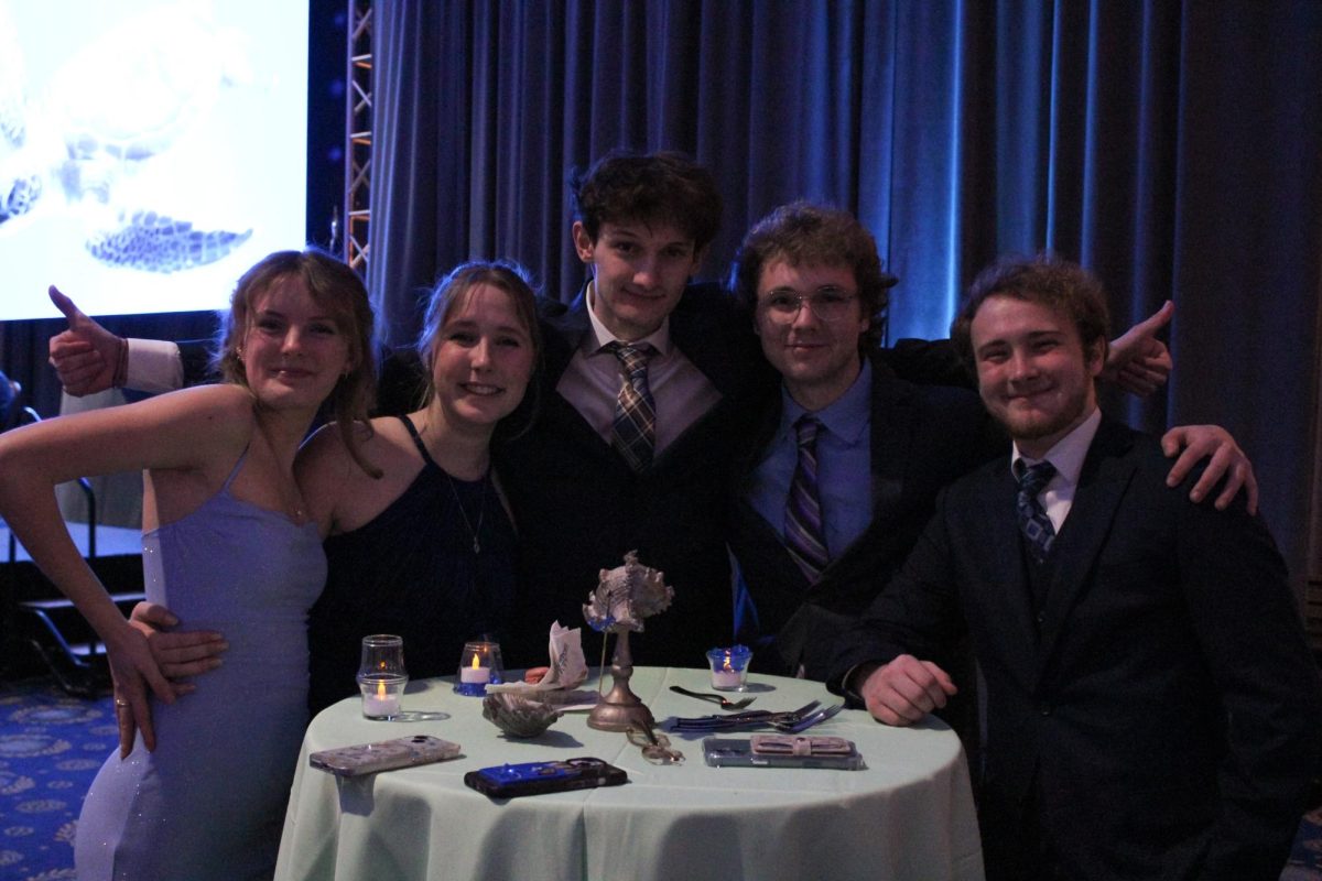 Group of CNU students pose for a group photo at their table