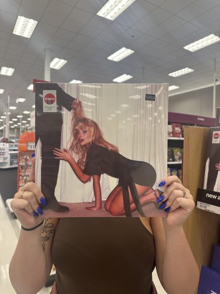 Digital Media Manager Lindsay Deyton
holding “Man’s Best Friend” vinyl. Photo
taken by Alyssa Tillman