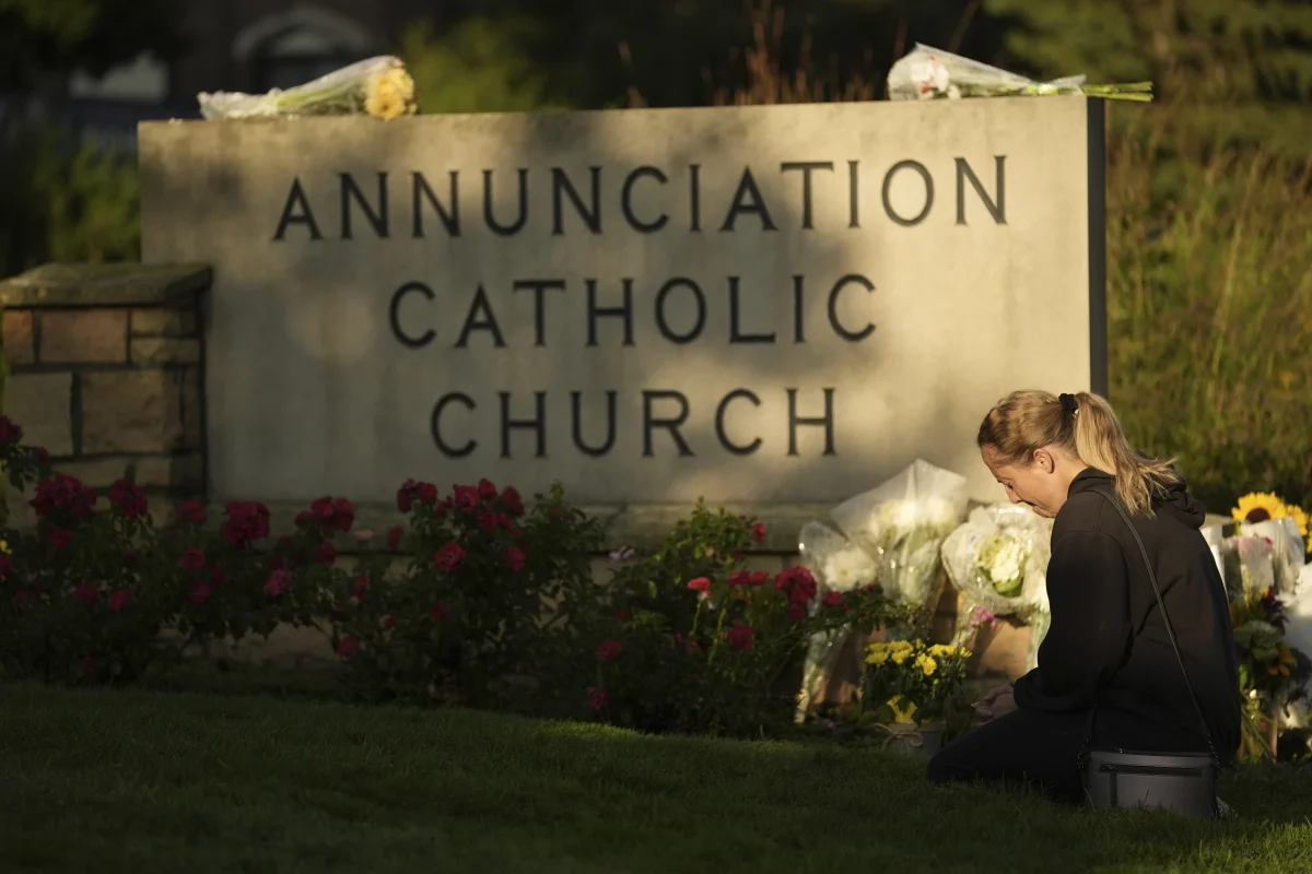 Woman kneeling by a makeshift memorial at Annunciation Catholic
Church after shooting in Minneapolis. Photo taken from AP News by
Abbie Parr.