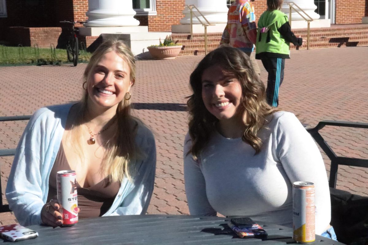 CNU students pose for a photo at a table in the Trible Plaza